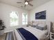 Cozy bedroom with natural light, featuring a ceiling fan, light-colored walls, and minimalist decor at 3199 Windhaven Ln, Tega Cay, SC 29708