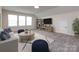 Spacious bonus room with a comfortable seating area, neutral decor, and large windows for natural light at 3199 Windhaven Ln, Tega Cay, SC 29708