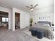 Bright main bedroom featuring a ceiling fan, plush carpets, and an en-suite bathroom at 3199 Windhaven Ln, Tega Cay, SC 29708