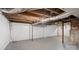 Unfinished basement with exposed ceiling, white walls and concrete flooring provides an open area for customization at 331 5Th Se Ave, Hickory, NC 28602