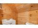 Quaint bathroom featuring wood-paneled walls, and a compact vanity at 331 5Th Se Ave, Hickory, NC 28602