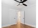 Bedroom features wood floors, ceiling fan, and neutral walls and open doorways at 331 5Th Se Ave, Hickory, NC 28602
