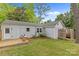 Backyard with wooden deck, outdoor shower, siding, and a lush lawn at 3320 Eastwood Dr, Charlotte, NC 28205