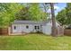 Backyard view with a wooden deck, outdoor shower and partial brick and light-blue siding at 3320 Eastwood Dr, Charlotte, NC 28205