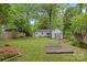 Beautiful backyard featuring a well-maintained lawn, a garden with raised beds, and a deck at 3320 Eastwood Dr, Charlotte, NC 28205