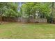 Well-maintained backyard featuring a wooden fence and perimeter landscaping with mulch at 3320 Eastwood Dr, Charlotte, NC 28205