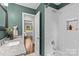 Bathroom with a white-tiled shower and granite countertops, next to home office at 3320 Eastwood Dr, Charlotte, NC 28205