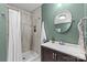 Cozy bathroom with walk-in shower and vanity with dark wood cabinet and a modern sink and fixtures at 3320 Eastwood Dr, Charlotte, NC 28205