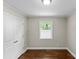 Cozy bedroom with hardwood floors, a closet, and a window with white blinds at 3320 Eastwood Dr, Charlotte, NC 28205