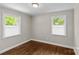 Bright bedroom featuring hardwood floors and white-trim windows providing ample natural light at 3320 Eastwood Dr, Charlotte, NC 28205