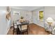 Well-lit dining area with hardwood floors, a stylish table, and bright natural light from a nearby window at 3320 Eastwood Dr, Charlotte, NC 28205