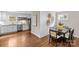 Open-concept dining area adjacent to the kitchen featuring a modern table set and decorative wall art at 3320 Eastwood Dr, Charlotte, NC 28205