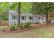 Charming home featuring a brick exterior, a welcoming front porch, and a lush landscaped yard at 3320 Eastwood Dr, Charlotte, NC 28205