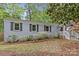 Charming home featuring a brick exterior, a welcoming front porch, and a lush landscaped yard at 3320 Eastwood Dr, Charlotte, NC 28205