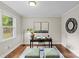 Bright home office with stylish decor, a dark wooden desk, and a large window view at 3320 Eastwood Dr, Charlotte, NC 28205