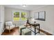Cozy home office featuring a dark wooden desk, green ottomans, and bright natural light at 3320 Eastwood Dr, Charlotte, NC 28205