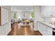 Bright, modern kitchen with granite countertops, white cabinets and views to dining and living rooms at 3320 Eastwood Dr, Charlotte, NC 28205