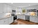 Bright kitchen featuring white cabinetry, granite countertops, stainless steel appliances, and stylish floating shelves at 3320 Eastwood Dr, Charlotte, NC 28205