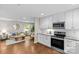 Open floor plan, eat-in kitchen with stainless appliances, granite counters and view into living room at 3320 Eastwood Dr, Charlotte, NC 28205