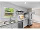 Updated kitchen featuring white cabinets, stainless steel appliances and fixtures, granite countertops, and dark hardwood floors at 3320 Eastwood Dr, Charlotte, NC 28205