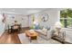 Bright living room showcasing neutral tones, stylish furnishings, hardwood floors, and a glimpse into the dining area at 3320 Eastwood Dr, Charlotte, NC 28205