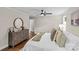 Bedroom with hardwood floors, dresser, and an ensuite bathroom in the hallway at 3320 Eastwood Dr, Charlotte, NC 28205