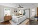 Main bedroom with a ceiling fan, ensuite bath, and hardwood floors at 3320 Eastwood Dr, Charlotte, NC 28205