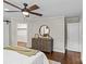View of bedroom's wooden dresser, ceiling fan, ensuite bathroom and walk-in closet at 3320 Eastwood Dr, Charlotte, NC 28205
