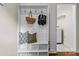 Mudroom featuring built-in storage, a bench, and hooks, with an adjacent laundry area at 3320 Eastwood Dr, Charlotte, NC 28205