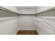 Spacious walk-in closet featuring ample shelving and wooden rods for optimal organization and storage at 3320 Eastwood Dr, Charlotte, NC 28205