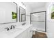 Bathroom with a double vanity, modern black fixtures, and a glass-enclosed shower at 404 S Greenbriar Rd, Statesville, NC 28625