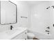 Bright bathroom featuring a single sink vanity and a tub shower combo with modern fixtures at 404 S Greenbriar Rd, Statesville, NC 28625