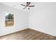 A bright and airy bedroom featuring a ceiling fan and a large window overlooking nature at 404 S Greenbriar Rd, Statesville, NC 28625
