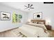 Staged bedroom with a large window and a ceiling fan, showcasing a bright and airy space at 404 S Greenbriar Rd, Statesville, NC 28625