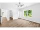 A bright bedroom with a ceiling fan, closet and natural light from a large window at 404 S Greenbriar Rd, Statesville, NC 28625