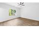 Bright, minimalist bedroom with a large window and neutral tones at 404 S Greenbriar Rd, Statesville, NC 28625