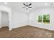 Bright living room features hardwood floors, vaulted ceilings, and large windows with scenic views at 404 S Greenbriar Rd, Statesville, NC 28625