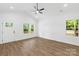 Bright living room features hardwood floors, vaulted ceilings, and large windows with scenic views at 404 S Greenbriar Rd, Statesville, NC 28625