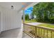 View of a covered porch with a wooden railing and a view of the neighborhood street at 404 S Greenbriar Rd, Statesville, NC 28625