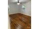 Spacious bedroom featuring hardwood floors, neutral walls, ceiling fan, and natural light through windows at 4100 Howie Cir, Charlotte, NC 28205