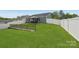 Spacious backyard featuring a well-maintained lawn, charming gazebo, and secure white fencing at 4205 Jones Creek Ln, Charlotte, NC 28215
