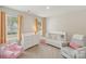 Bedroom with a crib, dresser, chair, and natural light at 4205 Jones Creek Ln, Charlotte, NC 28215