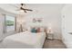 Sunlit bedroom showcasing a comfortable bed, neutral walls, and a ceiling fan at 4205 Jones Creek Ln, Charlotte, NC 28215