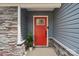 Inviting front entrance with a vibrant red door, stone accents, and modern hardware at 4205 Jones Creek Ln, Charlotte, NC 28215