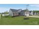 Well-maintained home with blue siding, stone accents, green lawn, and tree at 4205 Jones Creek Ln, Charlotte, NC 28215