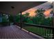 Inviting covered back deck with wood flooring and picturesque sunset views overlooking manicured backyard at 444 Snapdragon Dr, Clover, SC 29710