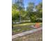 Inviting backyard with fire pit and beautiful view of the water and lush trees, perfect for outdoor gatherings at 444 Snapdragon Dr, Clover, SC 29710