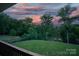 Expansive backyard featuring lush grass, mature trees, and a tranquil view from the upper deck at 444 Snapdragon Dr, Clover, SC 29710