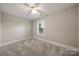 Neutral bedroom with a ceiling fan, plush carpet, and a bright window at 444 Snapdragon Dr, Clover, SC 29710