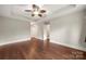 Large primary bedroom with hardwood floors, tray ceiling, and ensuite bath access at 444 Snapdragon Dr, Clover, SC 29710